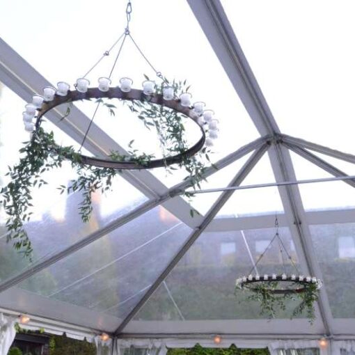 Circular Chandeliers with Votive Candle hanging under a tent in the rear Courtyard at The Foundry.