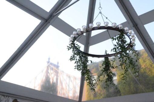 Circular Chandeliers with Votive Candle hanging under a tent in the rear Courtyard at The Foundry.