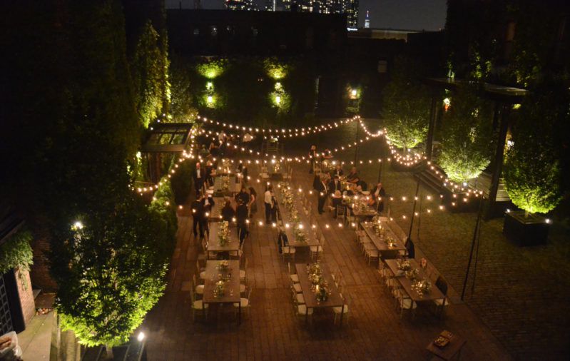 String Lights suspended with stand above the rear courtyard at The Foundry located in Long Island City, New York - Wedding Lighting
