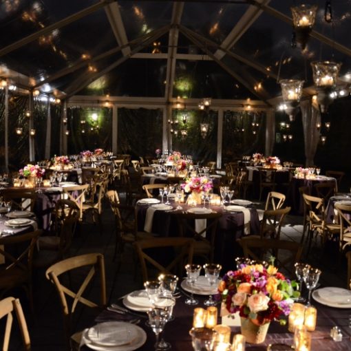 Pinspots focused on table centerpieces under tent in the courtyard at The Foundry located in Long Island City, New York
