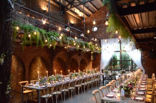 Pendant Lamps suspended in the main room with ivy suspended along mezzanine level in The Foundry located in Long Island City, New York - Wedding Lighting