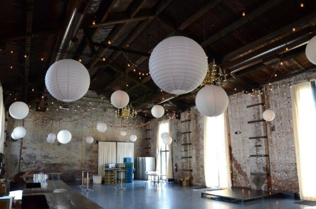 String Lights suspended overhead with paper lanterns at The Green Building located in Brooklyn, New York