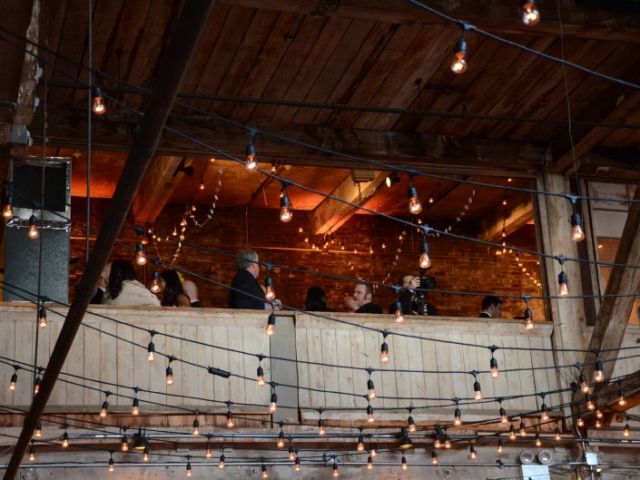 The Greenpoint Loft (Brooklyn, NY) - String Lights suspended with S14 bulbs in a Zigzag Pattern under the high ceiling area on the main floor with Up-Lights on the mezzanine level