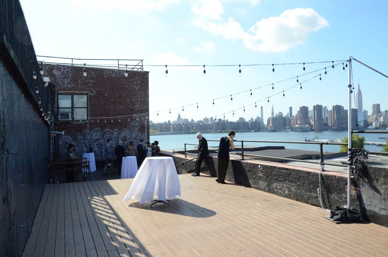 The Greenpoint Loft (Brooklyn, NY) - 150ft of String Lights with S14 bulbs suspended in a zigzag pattern from  lighting stands on the outdoor rooftop.