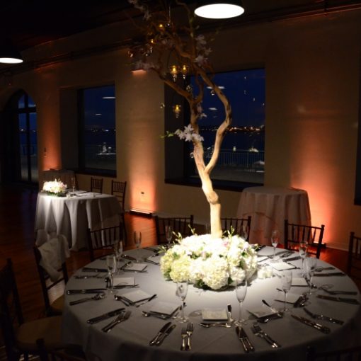 Pinspots focused on table centerpieces and Up-lights along the perimeter walls of the 1st floor at The Liberty Warehouse located in Brooklyn, NY