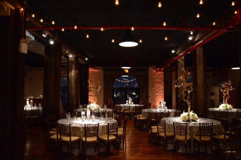 The Liberty Warehouse (Brooklyn, New York) - String Lights with S14 bulbs suspended in a Zigzag pattern over dance floor with Table Centerpiece Pin-Spots with Up-Lights along Perimeter Wall