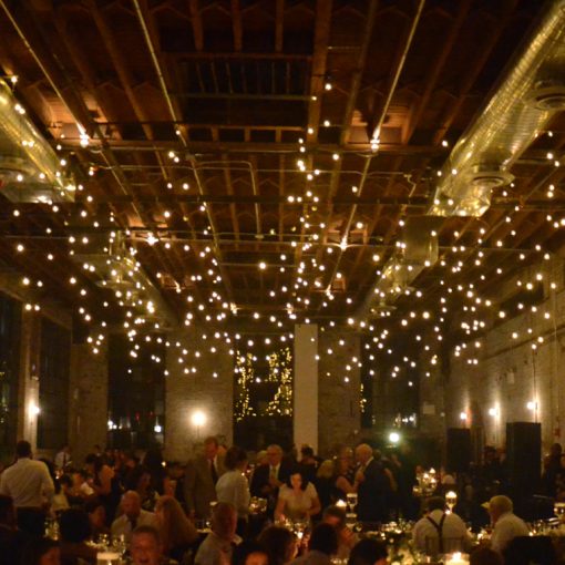 String Lights suspended with multiple swoops over dance floor area for a wedding reception at 99 Scott located in Brooklyn, New York