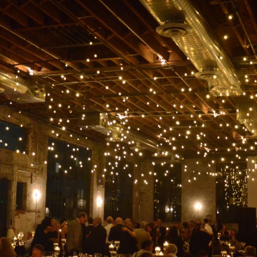String Lights suspended with multiple swoops over dance floor area for a wedding reception at 99 Scott located in Brooklyn, New York