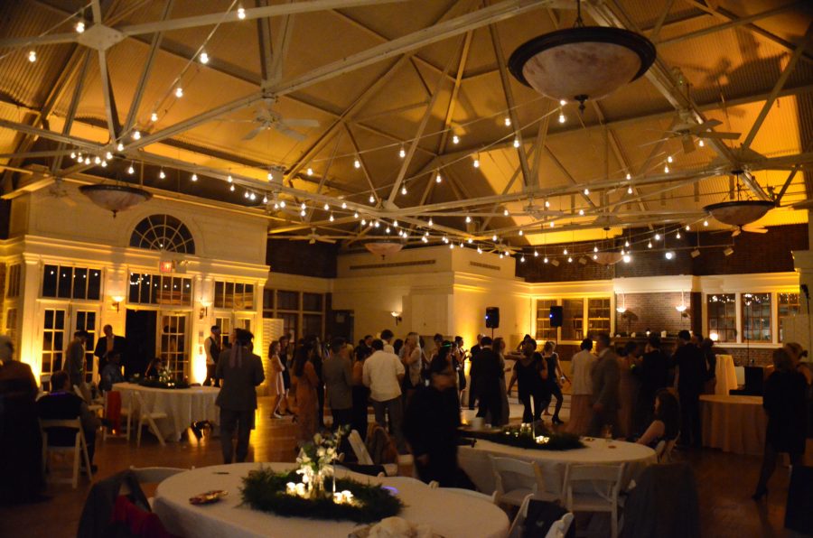 String Lights suspended overhead with amber up-lights along the perimeter wall for a wedding at The Prospect Park Picnic House located in Brooklyn, New York