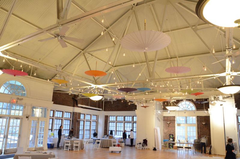 The Prospect Park Picnic House (Brooklyn, New York) - String Lights w/ various color paper parasol umbrellas suspended overhead