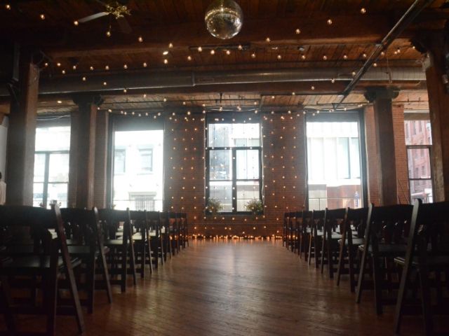 The Dumbo Loft (Brooklyn, New York) - String Lights suspended Vertically as a backdrop behind ceremony with String Lights suspended in a zigzagging pattern between center columns