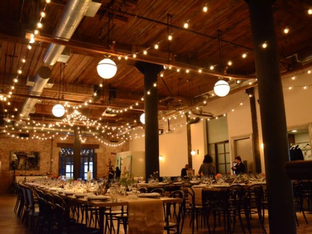 The Wythe Hotel (Brooklyn, New York) - String Lights suspended over head in Circular Pattern with String Lights suspended in Parallel Lines