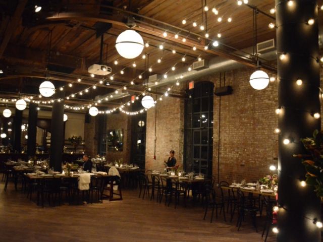 The Wythe Hotel (Brooklyn, New York) - String Lights suspended over head in V-Shaped Pattern with a column wrapped in lights