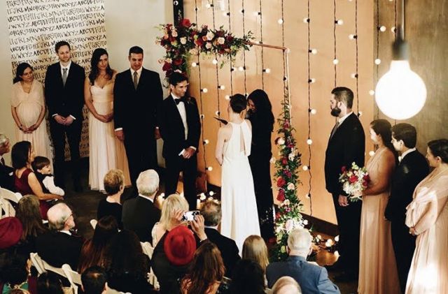 String Lights suspended vertically against wall behind ceremony
