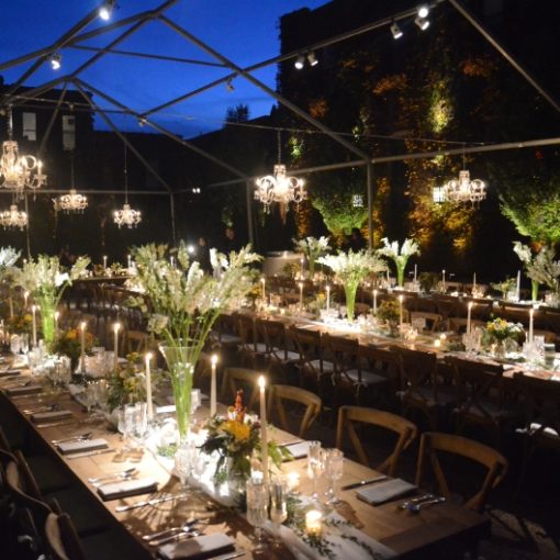 Pinspots focused on table centerpieces under tent in the courtyard at The Foundry located in Long Island City, New York