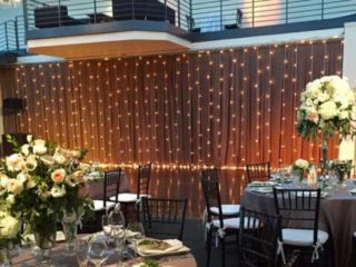 String Lights suspended vertically as backdrop against wall for a wedding at The Tribeca Rooftop located in New York City