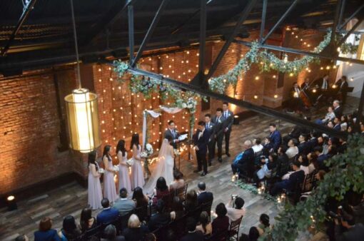 String Lights hanging vertically as a backdrop behind the ceremony area for a wedding at 26 Bridge (Brooklyn, NY)