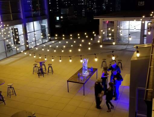 String Lights hanging above the outdoor area at The Bridgepoint (Brooklyn, NY).