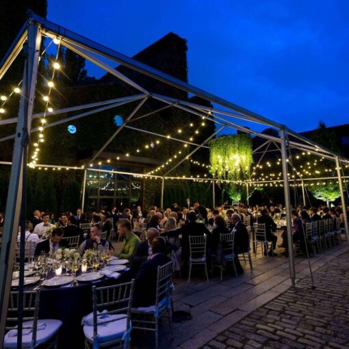 Warm White String Lights for a wedding hanging in the rear courtyard of the Foundry from a tent frame.