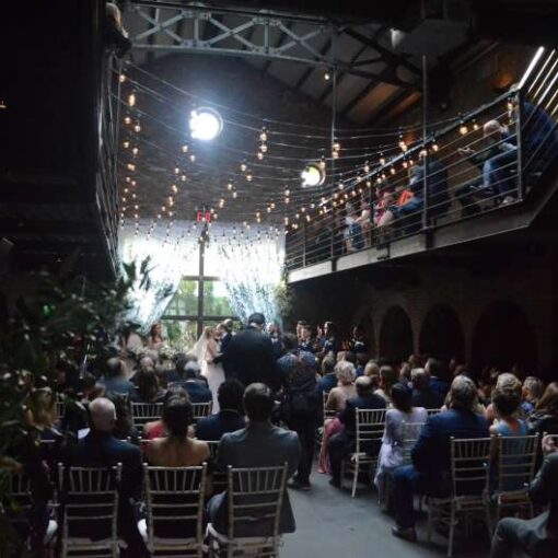 Warm White String Lights hanging in the main room for a wedding at The Foundry.