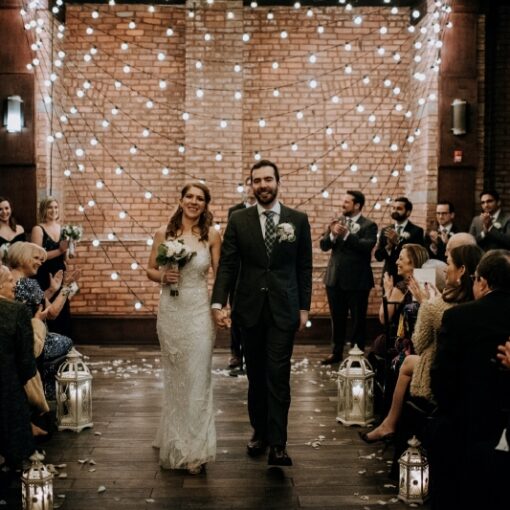 A section of swooping String Lights hanging against a wall for a wedding at 26 Bridge (Brooklyn, NY)