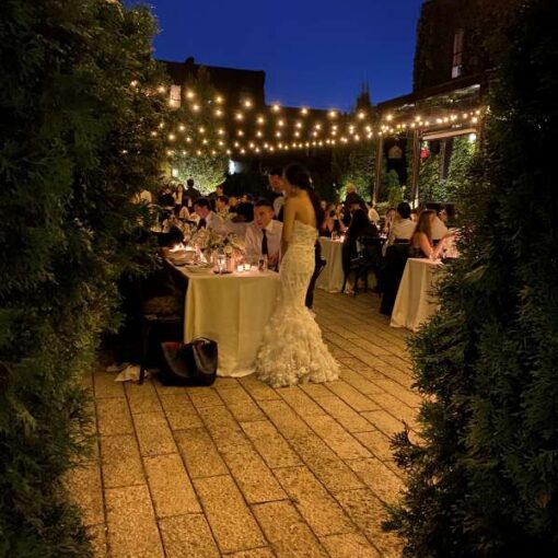 String Lights with Warm White bulbs suspended without lighting stands above the courtyard for a wedding at The Foundry.
