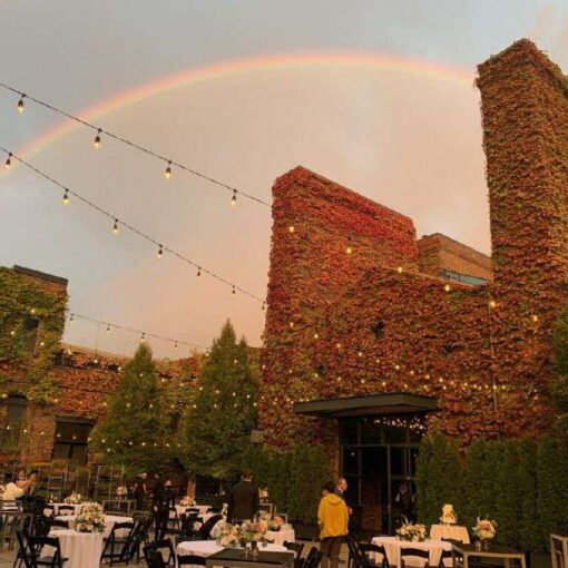 Rainbow and String Lights suspended above the courtyard on a wedding day at The Foundry