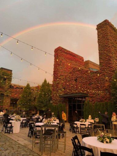 Rainbow and String Lights suspended above the courtyard on a wedding day at The Foundry