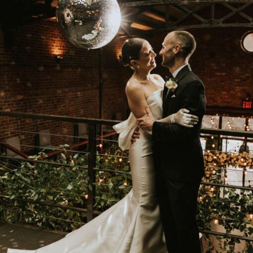 A Mirror Ball w/ motor and spotlight along with String Lights hanging in the main room for a wedding at The Foundry