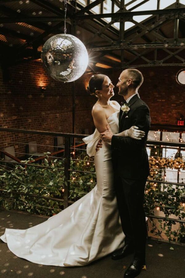A Mirror Ball w/ motor and spotlight along with String Lights hanging in the main room for a wedding at The Foundry