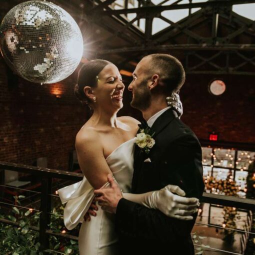 A Mirror Ball w/ motor and spotlight along with String Lights hanging in the main room for a wedding at The Foundry
