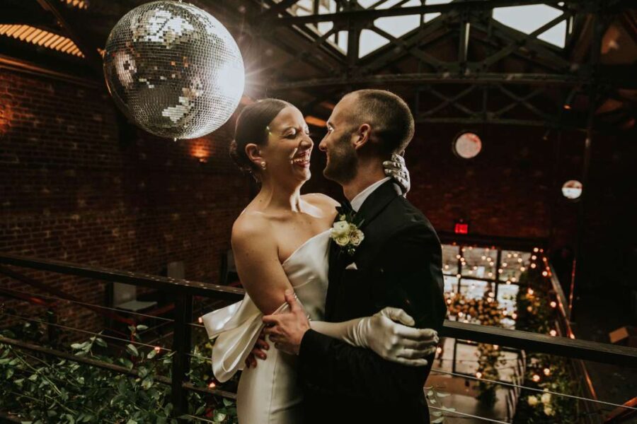 A Mirror Ball w/ motor and spotlight along with String Lights hanging in the main room for a wedding at The Foundry