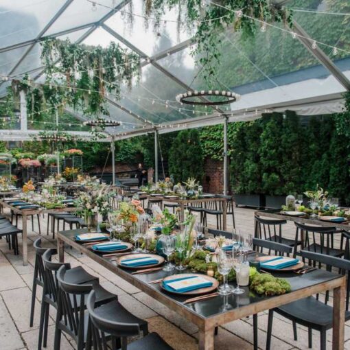String Lights and Circular Chandeliers w/ Votive Candles suspended under tent for a wedding reception at The Foundry