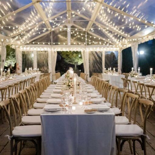 String Lights hanging outdoors under a clear top tent for a wedding at The Foundry