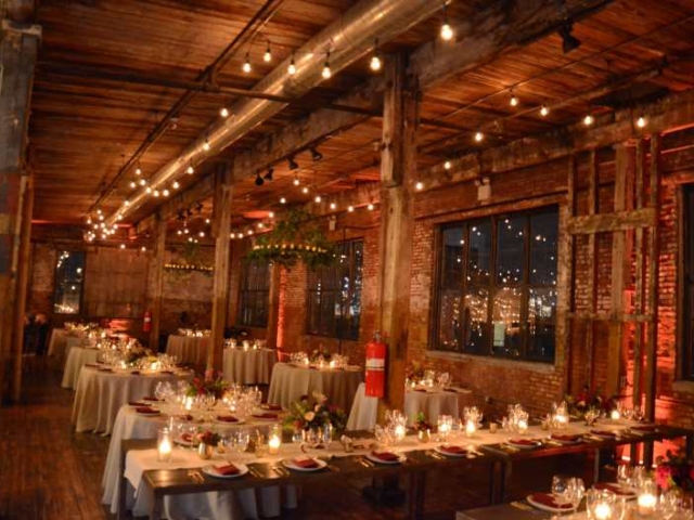 String Lights suspended in a parallel lines under lower ceiling area on the BAR and NON-BAR side of the main floor at The Greenpoint Loft with Circular Chandeliers and Votive Candles.
