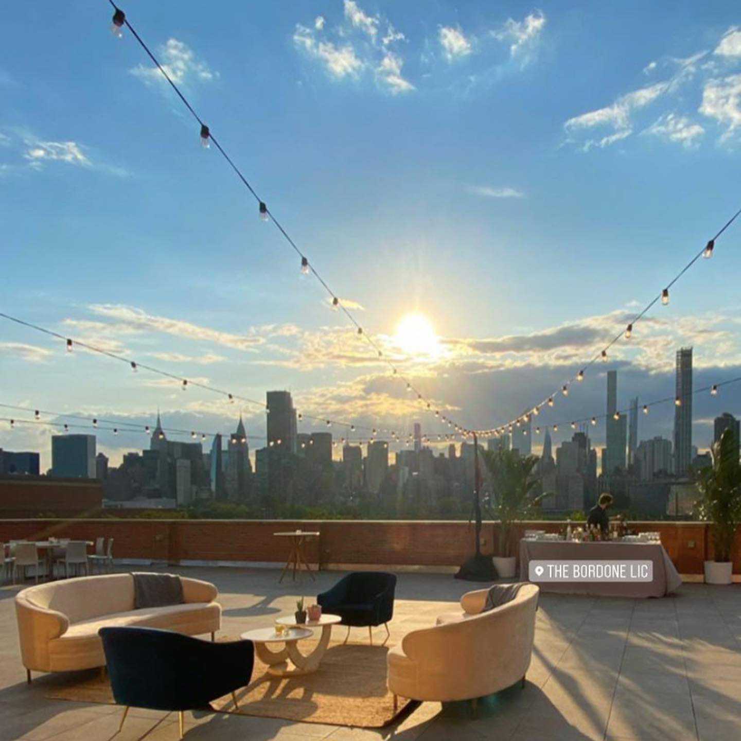 String Lights with stands hanging in a V-Shaped pattern above the outdoor terrace on the 3rd floor at The Bordone (L.I.C, NYC)