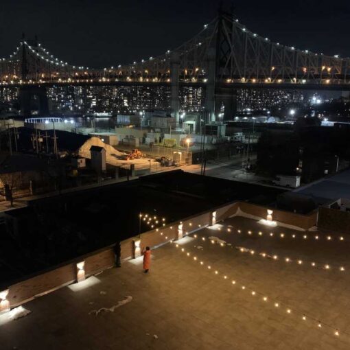 String Lights suspended in a V-Shaped pattern above the 3rd floor terrace at The Bordone (L.I.C., NY)