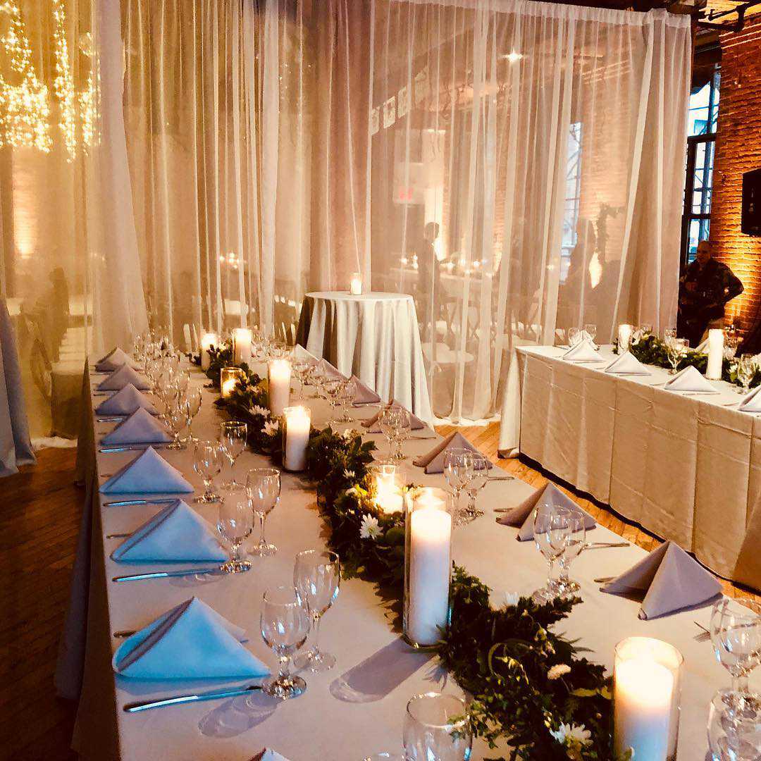 Icicile Fairy Lights hanging between the center columns and up-lights along the perimeter walls with sheer curtains at The Dumob Loft
