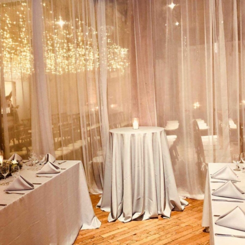 Icicile Fairy Lights hanging between the center columns with sheer curtains at The Dumob Loft