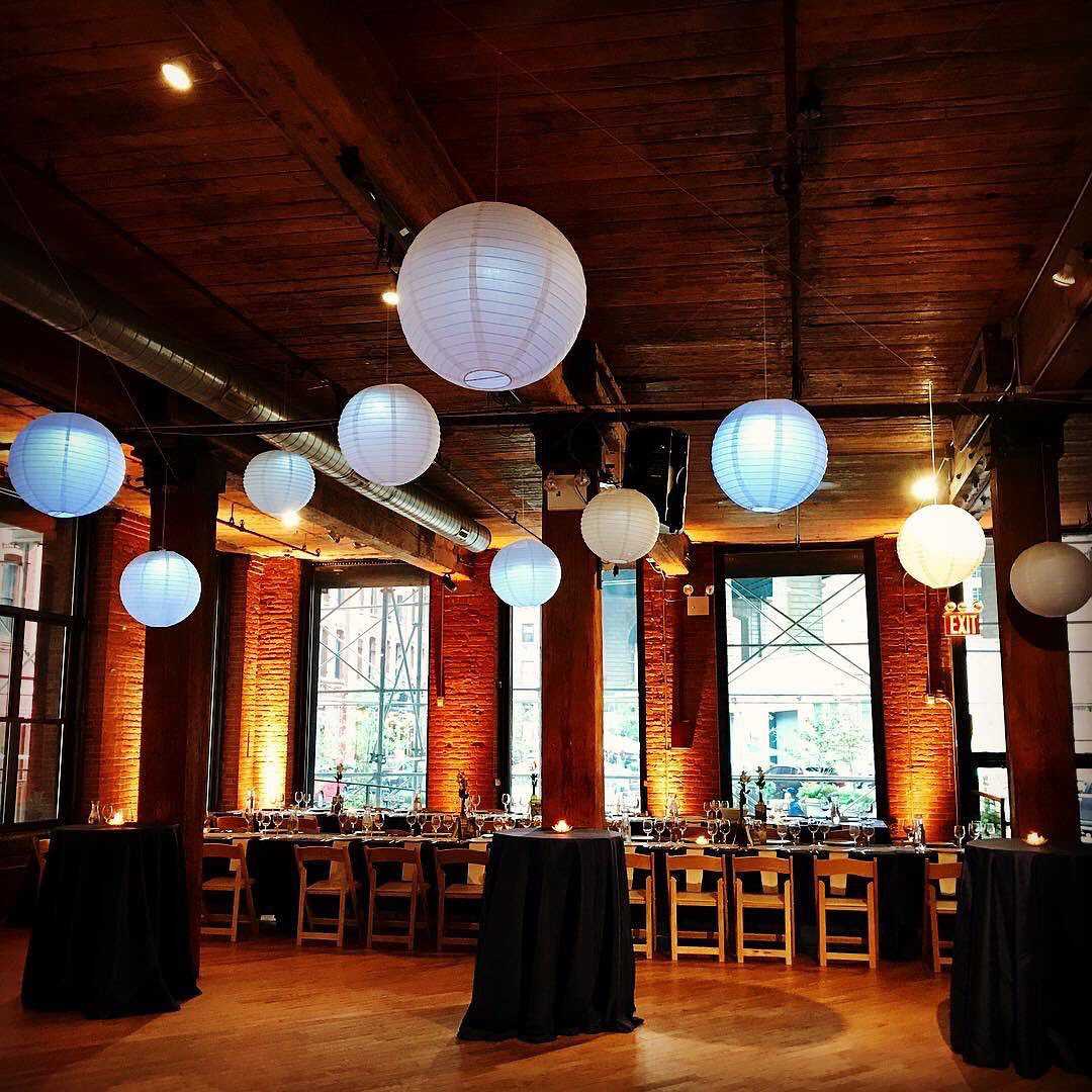 Paper Lanterns hanging overhead with Up-lights along the perimeter walls at The Dumob Loft