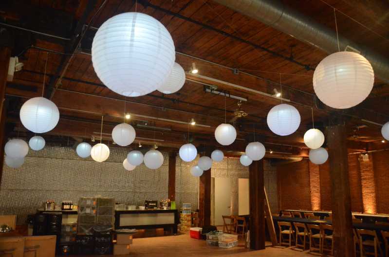 Paper Lanterns hanging overhead with Up-lights along the perimeter walls at The Dumob Loft