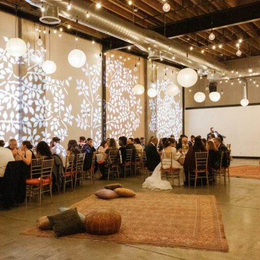 Stock Gobo images projected on wall along with String Lights w/ Paper Lanterns hanging above The Main Room at Dobbin St.