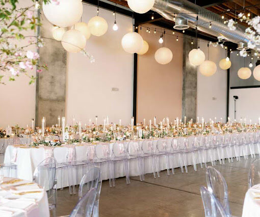 Paper Lanterns hanging from pendant lamps that are connected to String Lights hung overhead in the main room at Dobbin St..