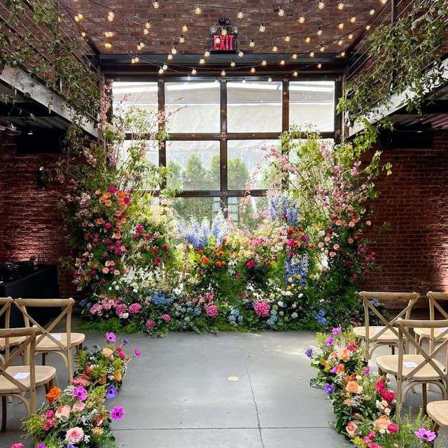 The Foundry (LIC, NY) Wedding Lighting - Large Floral Arrangement at the courtyard doors
