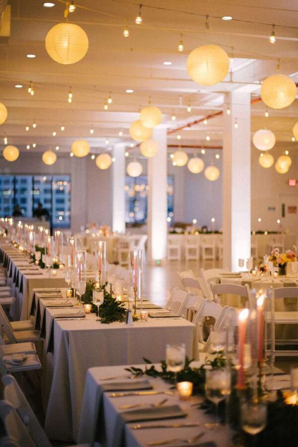 A combination of String Lights and White Paper Lanterns hanging together in the 3rd-floor reception room at The Bordone (Long Island City, New York City)