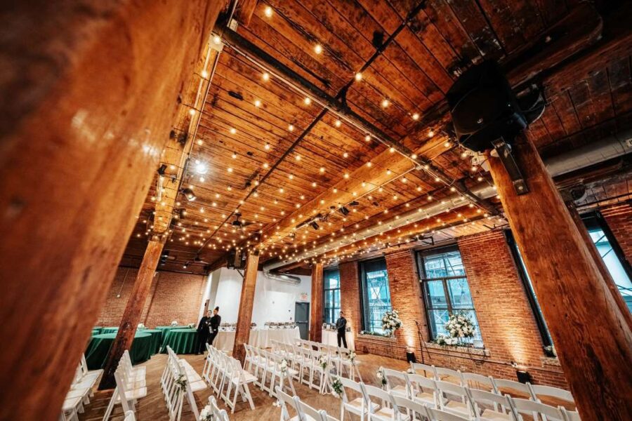 A canopy of String lighting with round G50 bulbs hanging between the center columns along with up-lights along the perimeter walls at The Dumbo Loft