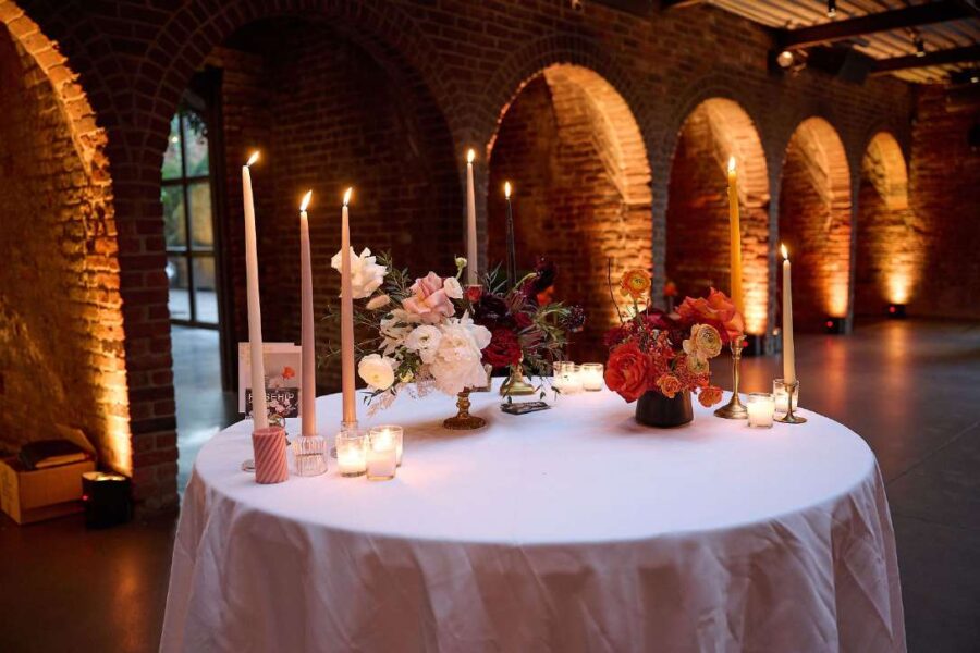 The Foundry - Long Island City, New York - The Main Room with Florals and Candles on a table and Up-Lights in alcoves.