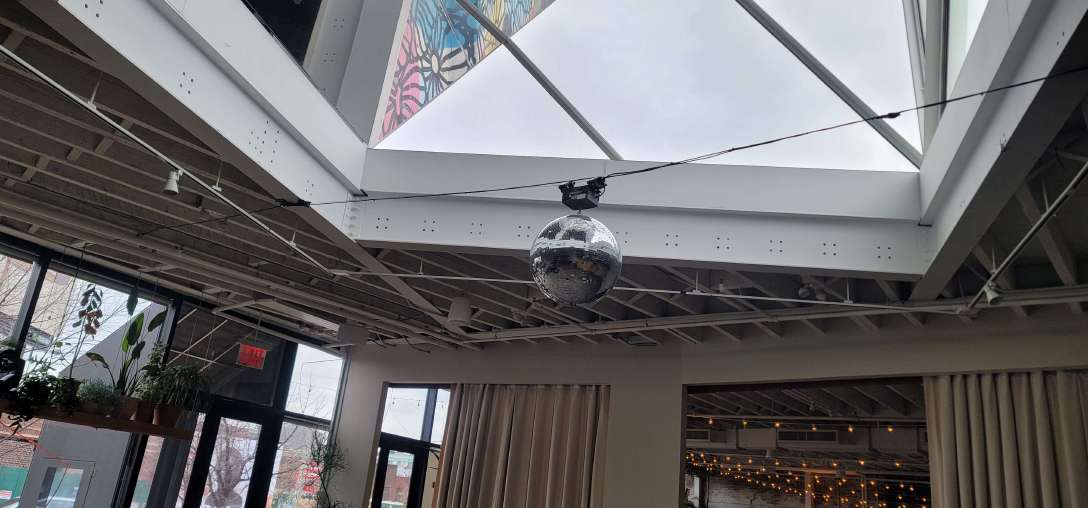 Mirror Ball Hanging Under Skylight for a Wedding Reception at Rule of Thirds (Brooklyn, NY)