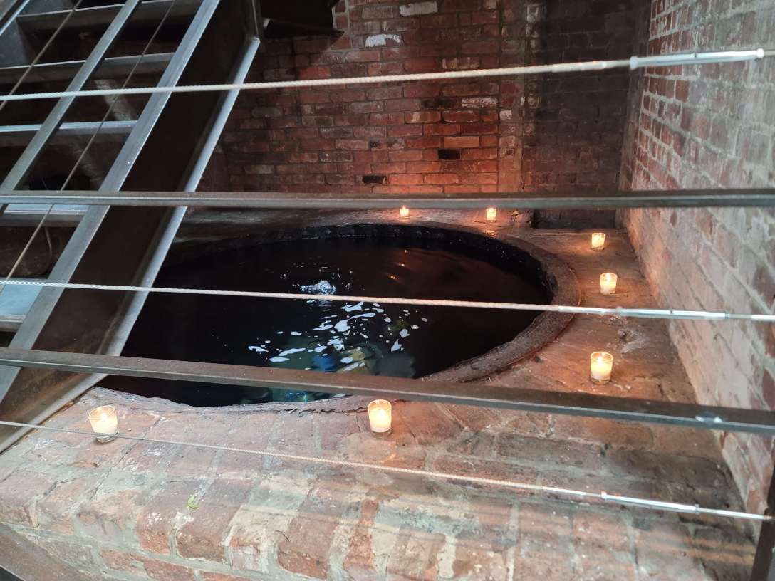 Votive Candles around the fountain under the stairway at The Foundry