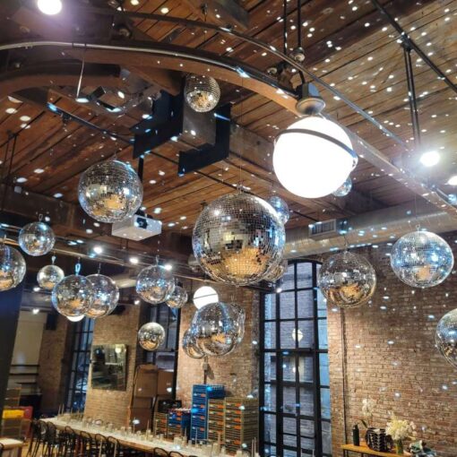 A cluster of Mirror Balls suspended above the dance floor inside The Wythe Hotel.